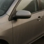 Close-up of a clean but dull-looking car exterior after washing, illustrating why a car still looks dirty after washing despite regular cleaning.