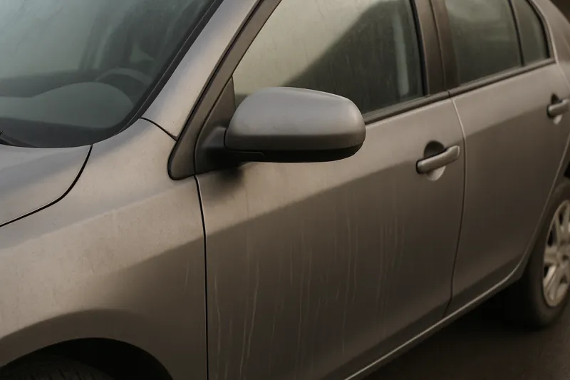 Close-up of a clean but dull-looking car exterior after washing, illustrating why a car still looks dirty after washing despite regular cleaning.