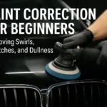 A person using a dual-action polisher on a black car hood to remove swirls, scratches, and dullness during paint correction.